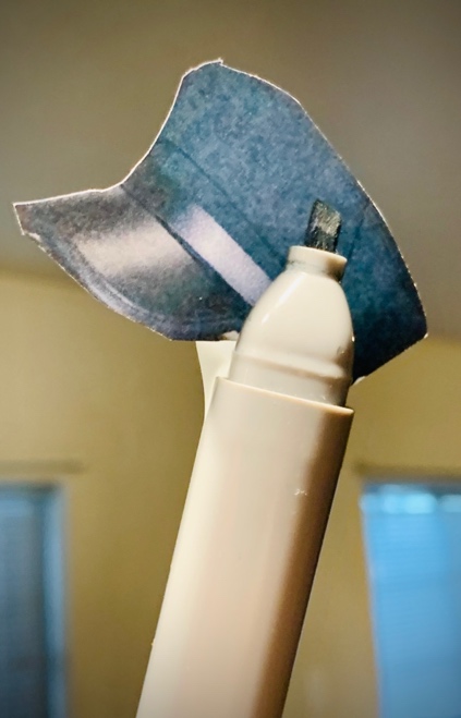 A white object with a black hat on it

Description automatically generated